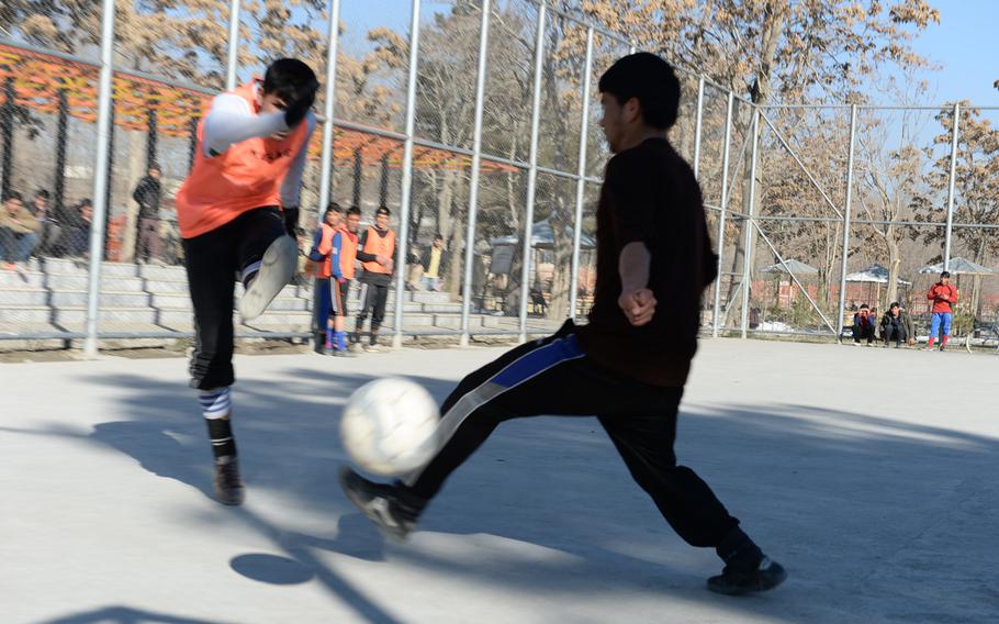 3:17 p.m. A soccer game at a park in western Kabul. 