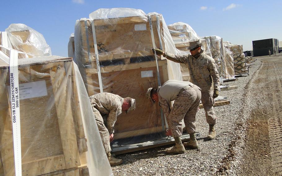 From left, Lance Cpl. Matthew Ford, Cpl. Matthew Pappas and Lance Cpl. Albert Adams, all of Redeployment and Retrograde in Support of Reset and Reconstitution Operations Group, or R4OG, prep a pallet of gear for transport from Camp Leatherneck, Afghanistan to I Marine Expeditionary Force at Camp Pendleton, Calif.