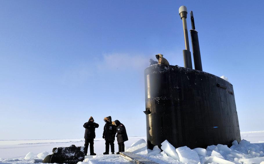 Members of the Applied Physics Laboratory Ice Station clear ice from the hatch of the Los Angeles-class submarine USS Annapolis after the sub broke through the ice while participating in Ice Exercise 2009 in the Arctic Ocean. A U.S. Navy Arctic Roadmap looks at what's needed in anticipation of increased traffic as Arctic ice melts, opening up trade routes and access to natural resources.