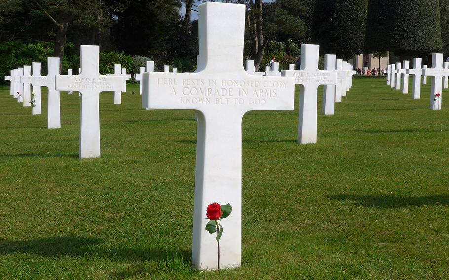 A single rose decorates the grave of an unknown soldier at Normandy American Cemetery at Colleville-sur-Mer, France. On a bluff overlooking Omaha Beach, the cemetery is the final resting place for 9,387 American war casualties.