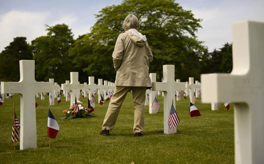 Jill Venskus of Chicago, Illinois, visits her uncle's grave after the Memorial Day ceremony at Lorraine American Cemetery Sunday, May 25, 2014, at St. Avold, France.