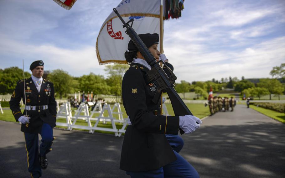 Members of the 18th Military Police Brigade out of Sembach Kaserne, Germany, present the colors at the Memorial Day ceremony at Lorraine American Cemetery Sunday, May 25, 2014, at St. Avold, France.