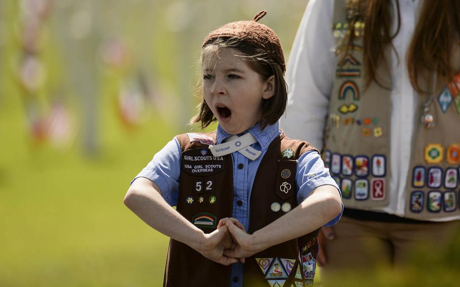 Skyler DiGeorge, a Brownie Girl Scout from Spangdahlem, Germany, yawns before presenting wreaths for the Memorial Day ceremony at Lorraine American Cemetery Sunday, May 25, 2014, at St.-Avold, France.