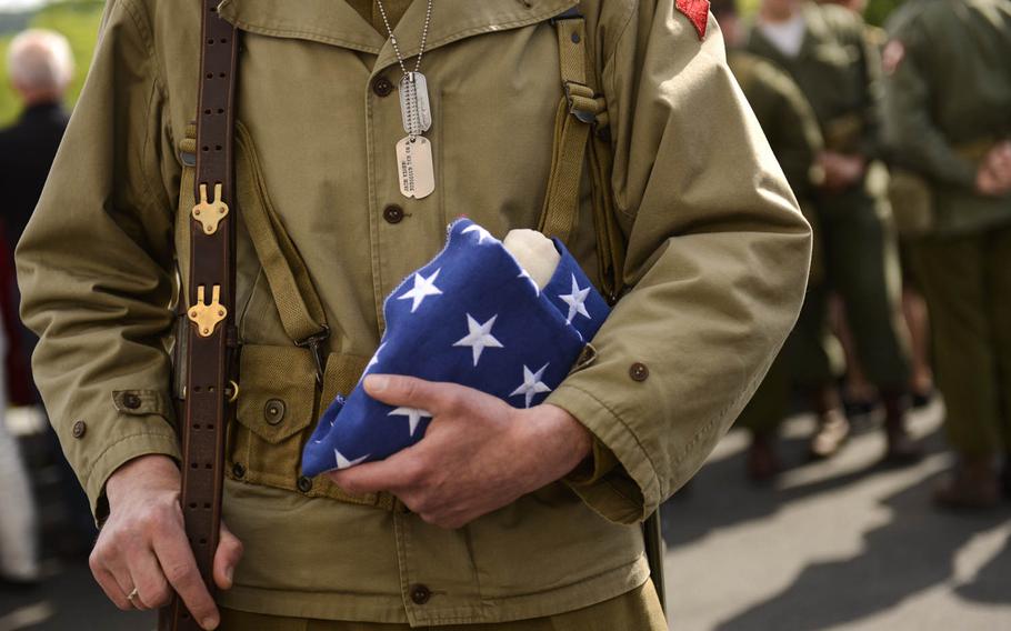 Marc Auer, a World War II re-enactor, wear a period uniform at the Memorial Day ceremony at Lorraine American Cemetery Sunday, May 25, 2014, at St.-Avold, France.