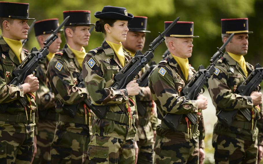 French servicemembers march at the Memorial Day ceremony at Lorraine American Cemetery Sunday, May 25, 2014, at St.-Avold, France.