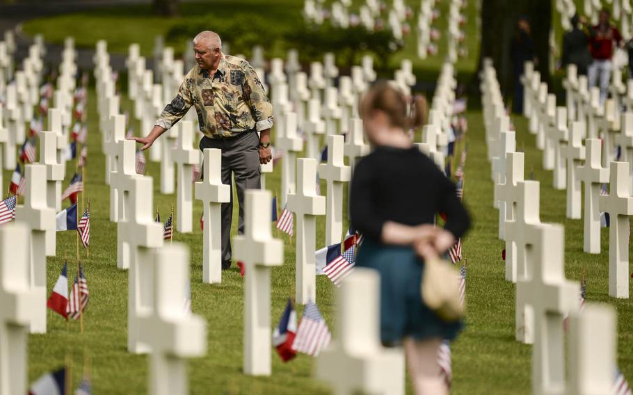 Kielar Hubert, an observer at the Memorial Day ceremony at Lorraine American Cemetery Sunday, May 25, 2014, at St.-Avold, France, touches a grave after the ceremony.