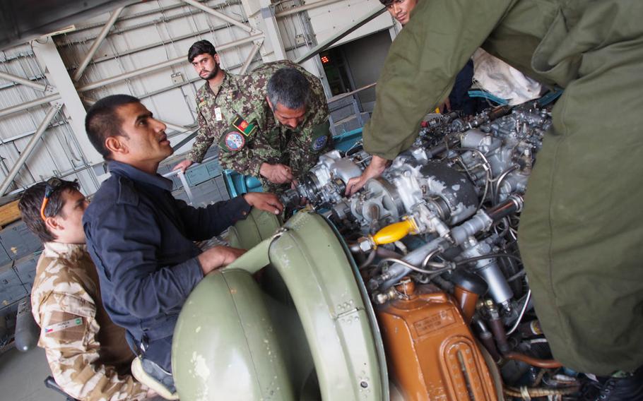 Afghan Air Force personnel perform maintenance on a helicopter while under the watch of Czech advisors. With no guarantees that foreign troops will be in Afghanistan past the end of the year, NATO trainers are trying to get the air force self-sustaining by the end of 2014.
