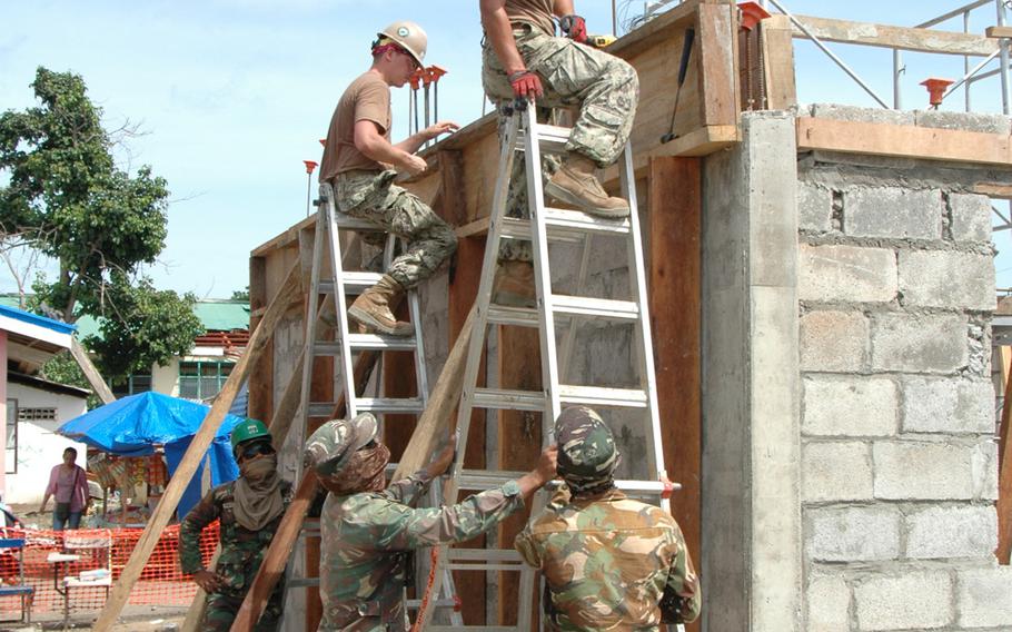 U.S. Navy Seabees and Filipino troops build classrooms in Tacloban, the Philippines, in July 2014. The island nation is still recovering from a devastating typhoon that hit more than seven months ago.