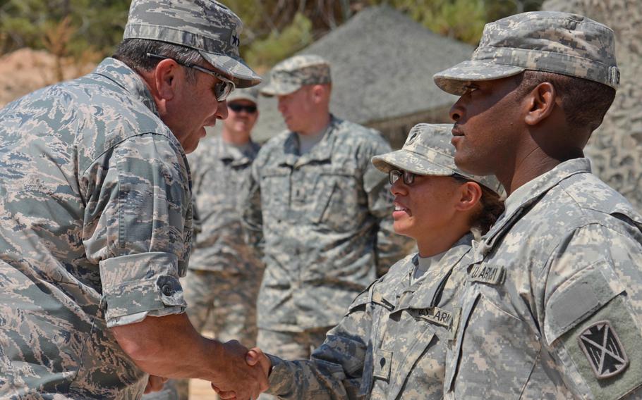 Gen. Philip Breedlove, supreme allied commander Europe, gives a coin to Spc. Alexis Juarez during his visit to the Turkish army base in Gaziantep, where the 5th Battalion, 7th Air Defense Artillery Regiment is deployed, Thursday, July 31, 2014.