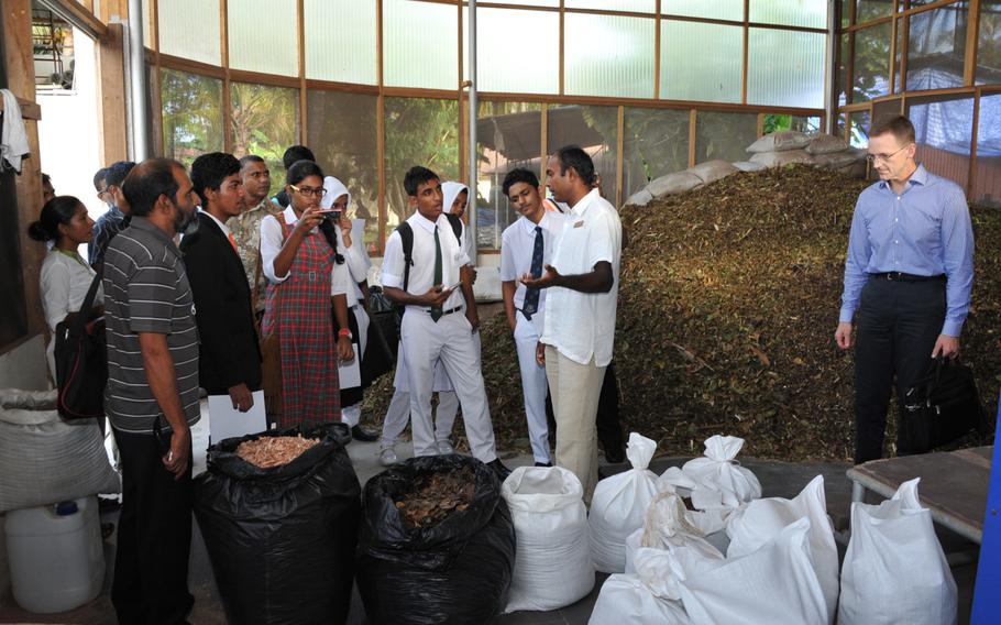 Brig. Gen. Mark McLeod of U.S. Pacific Command stands to the right during a tour of the operations of a Maldivian business using environmentaly sustainabile practices on June 4, 2014, during the South Asia Regional Environmental Security Forum, held June 2-5 in the Maldives. The annual forum is one of the ways PACOM uses to forge cooperation with Pacific nations over environmental security issues arising from global climate change.