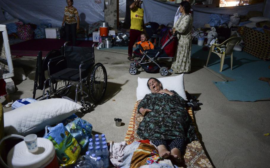 Displaced Iraqi Christians find shelter in a sweltering unfinished commercial building in Irbil, Iraq, Aug. 20, 2014. They fled their homes in fear of the Islamic State's advance in the Mosul region.