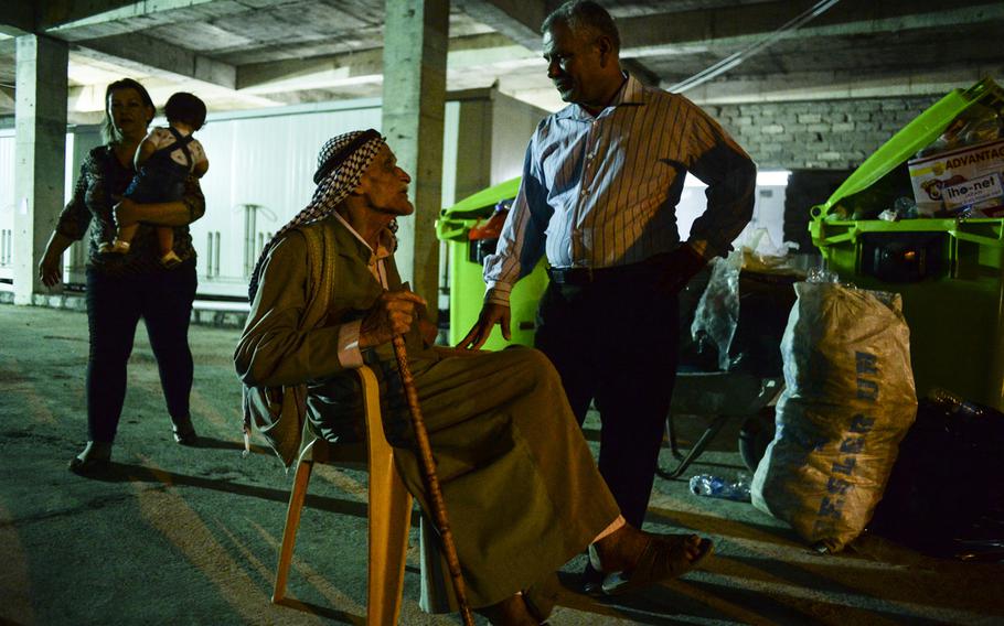 Displaced Iraqis find shelter in a sweltering unfinished commercial building in Irbil, Iraq, Aug. 20, 2014. They fled their homes in fear of the Islamic State's advance in the Mosul region.