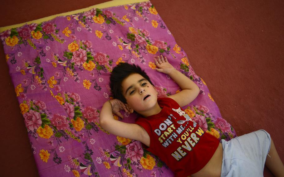 A disabled Iraqi boy is among displaced Christians staying in an unfinished commercial building in Irbil, Iraq, Aug. 21, 2014. The Christians fled their homes in fear of the Islamic State's advance in the Mosul region.