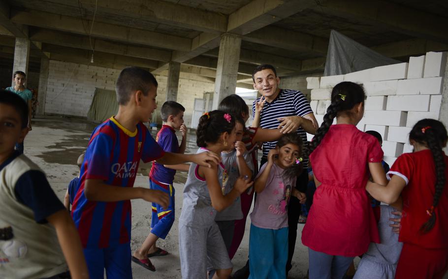 Martin Banni, a seminarian, is responsible for the Christian camp in Irbil, Iraq, which utilizes an unfinished building, Aug. 21, 2014. The Christians fled their homes in fear of the Islamic State's advance in the Mosul region.