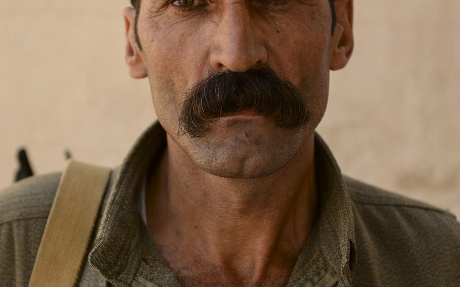 A Kurdistan Workers' Party guerrilla poses for a portrait in Makhmur, Iraq, Aug. 23, 2014. The men in the PKK treat their female counterparts as equals.