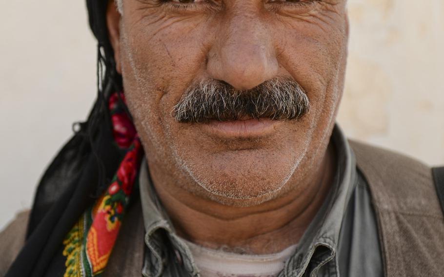 A Kurdistan Workers' Party guerrilla poses for a portrait in Makhmur, Iraq, Aug. 23, 2014. 