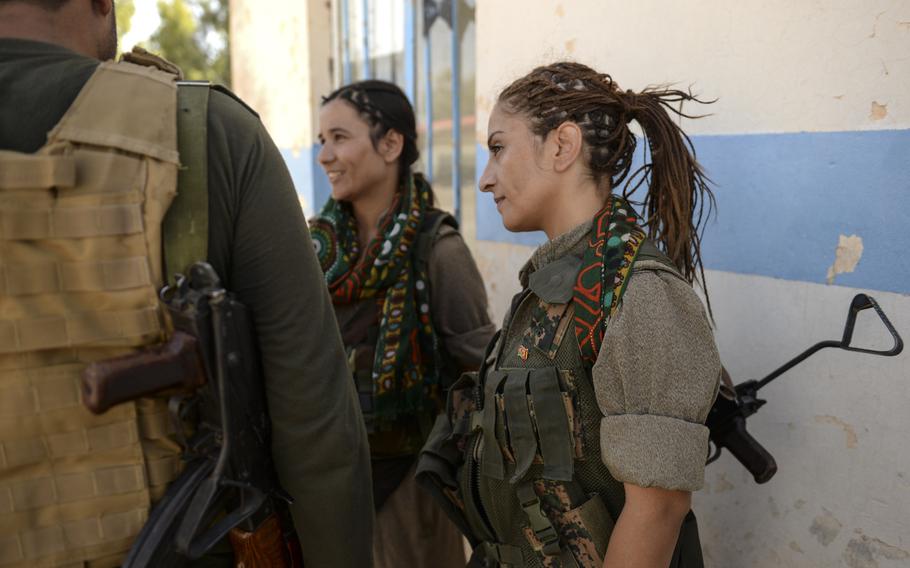 Zekia Karhan, 26, right, and Felice Budak, 24, middle, speak with a journalist in Makhmur, Iraq, Aug. 23, 2014. Karhan and Budak are guerrillas in the Kurdistan Workers' Party.