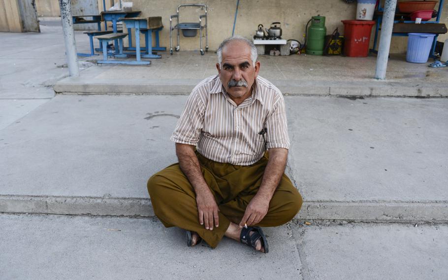 A displaced man poses for a portrait in the school where he and other Yazidis  been given shelter in the Ankawa district of Irbil, Iraq, Aug. 24, 2014.
