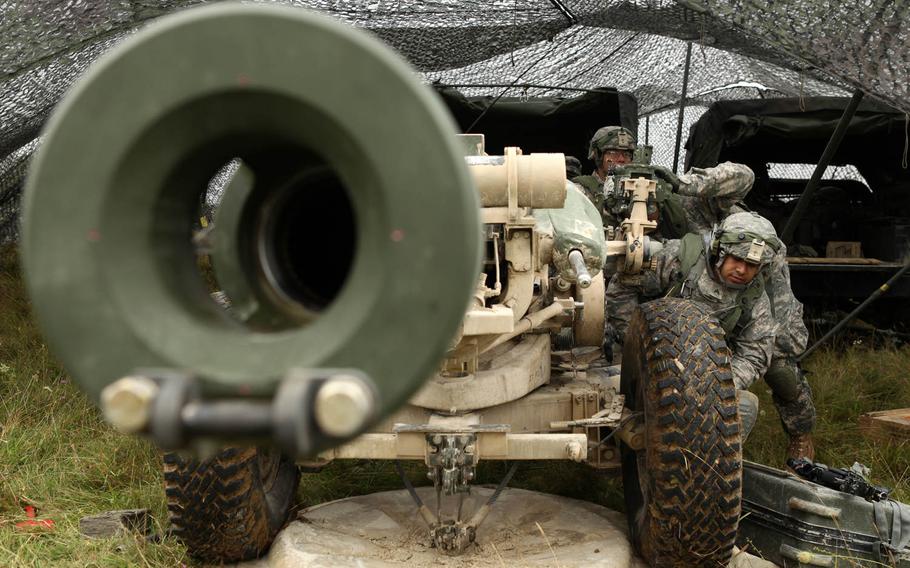U.S. soldiers with the 319th Airborne Field Artillery Regiment, 173rd Airborne Brigade, conduct a check on a M119A2 105mm howitzer during a training exercise as part of Saber Junction 2014 at the Joint Multinational Readiness Center in Hohenfels, Germany, Aug. 28, 2014.