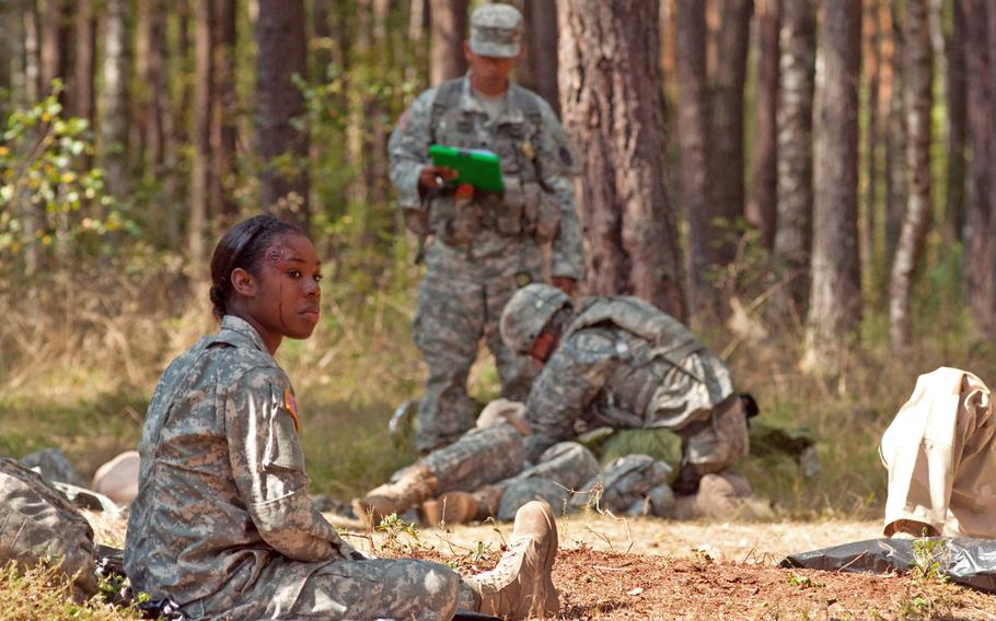Parts of the Expert Field Medical Badge evaluation held at Grafenwoehr, Germany, Sept. 4-9, 2014, tested candidates on their ability to handle complex casualty situations. Here, a candidate runs through basic triage while evaluators look on, Sept. 5, 2014.