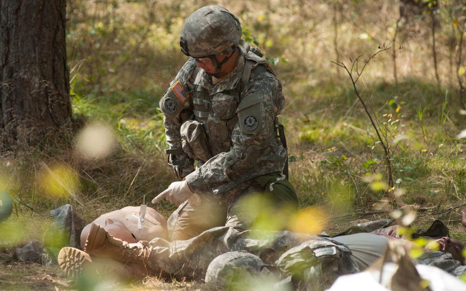 Spc. Douglas Sandoval, from the 2nd Cavalry Regiment, performs a simulated lung inflation Sept. 5, 2014, during the testing phase for the Expert Field Medical Badge held at Grafenwoehr, Germany,from  Sept. 4-9.