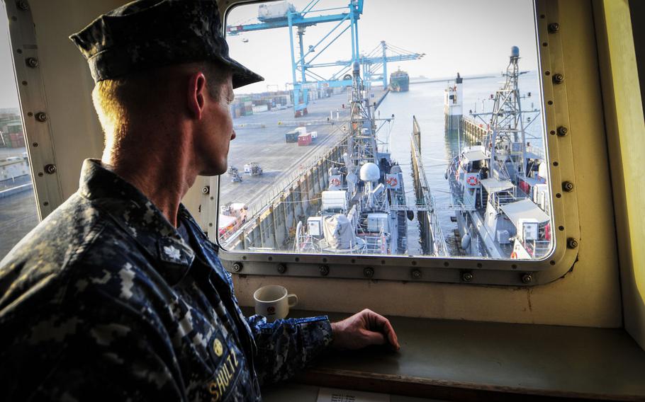 Cmdr. Thomas Shultz, commodore of Patrol Coastal Squadron 1, watches the coastal patrol ships USS Hurricane and USS Monsoon prepare to transit to Naval Support Activity Bahrain from a yacht carrier vessel, Aug. 13, 2014.  The Hurricane and Monsoon are the last two of 10 coastal patrol ships that are part of a realignment plan in the U.S. 5th Fleet area of responsibility.