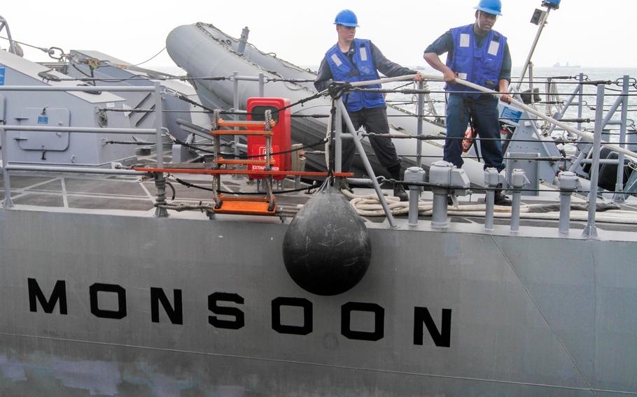 Deck crews moor the USS Monsoon to a new spot alongside the pier at Naval Support Activity Bahrain, Aug 28, 2014. The Monsoon and the USS Hurricane are undergoing a reactivation process at their new homeport. Both ships arrived here Aug. 13 on a commercial shipping vessel from Norfolk, Va.