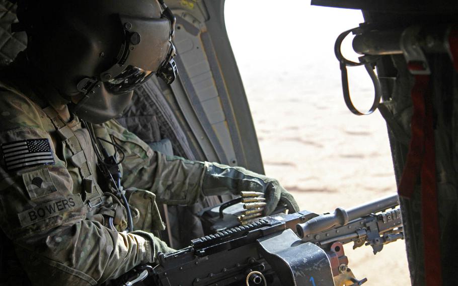 Spc. Matthew Bowers, a CH-47F Chinook helicopter crew chief with Task Force Flying Dragons, reloads an M240B machine gun aboard a Chinook during aerial door gunnery training Sept. 7, 2014, at a training site in Southern Afghanistan.