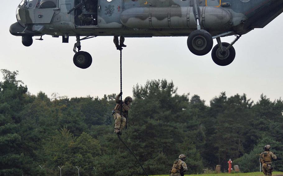 Special operations forces slide down the rope from a Czech MI-171 helicopter during a demonstration at Jackal Stone 14, an exercise hosted by the U.S. Special Operations Command Europe at Baumholder, Germany, Friday, Sept. 12, 2014. Forces from 10 nations are taking part in the event in numerous locations in Germany and the Netherlands.