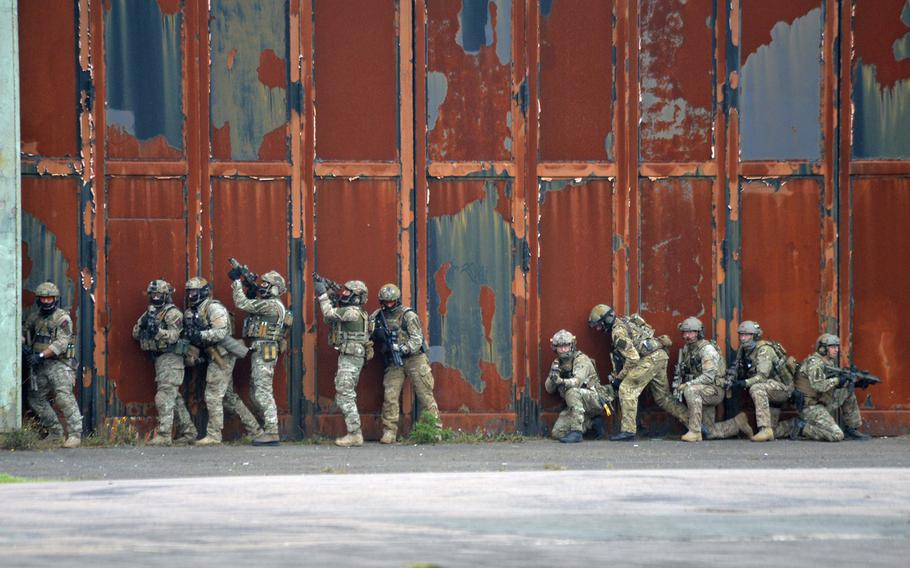 Special operations forces prepare to enter a building to search for terrorists during a demonstration at Jackal Stone 14, an exercise hosted by the U.S. Special Operations Command Europe at Baumholder, Germany, Friday, Sept. 12, 2014. Forces from 10 nations are taking part in the event in numerous locations in Germany and the Netherlands.