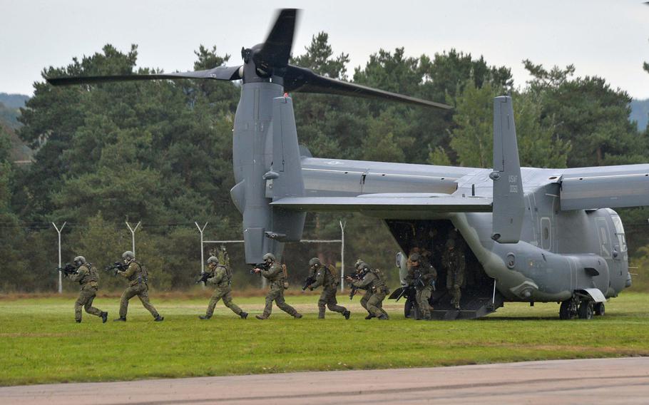 Special operations forces storm off  a U.S. Air Force CV-22 Osprey during a demonstration at Jackal Stone 14, an exercise hosted by the U.S. Special Operations Command Europe at Baumholder, Germany, Friday, Sept. 12, 2014. Forces from 10 nations are taking part in the event in numerous locations in Germany and the Netherlands.