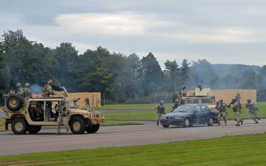Special operations forces surround the car of a "terrorist" trying to escape during a demonstration at Jackal Stone 14, an exercise hosted by the U.S. Special Operations Command Europe at Baumholder, Germany, Friday, Sept. 12, 2014. Forces from 10 nations are taking part in the event in numerous locations in Germany and the Netherlands.