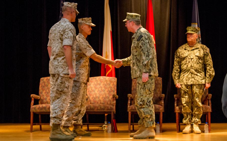 U.S. 5th Fleet Commander Vice Adm. John Miller, right, shakes hands with  Marine Brig. Gen. Carl Mundy III as the latter assumes command of Commander, Task Force 51, on Sunday, Sept. 14, 2014. Mundy will oversee the amphibious forces operating in the U.S. 5th Fleet area of responsibility.