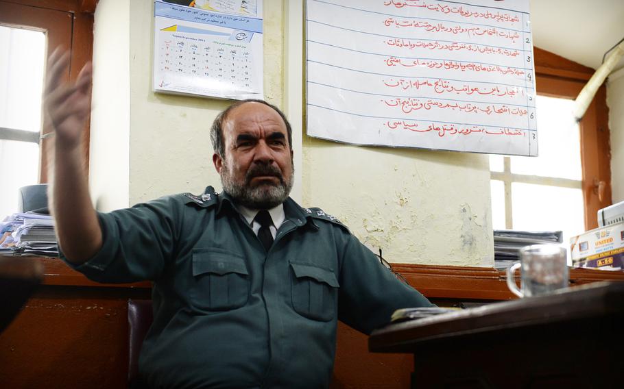 Afghan police Col. Sangar Khil gestures while discussing plans to provide security during the anticipated announcement of Afghanistan's disputed presidential election results. Police officials are hoping for peace but say they are planning for threats from insurgents as well as disgruntled political factions. Khil spoke on Wednesday, Sept. 17, 2014.