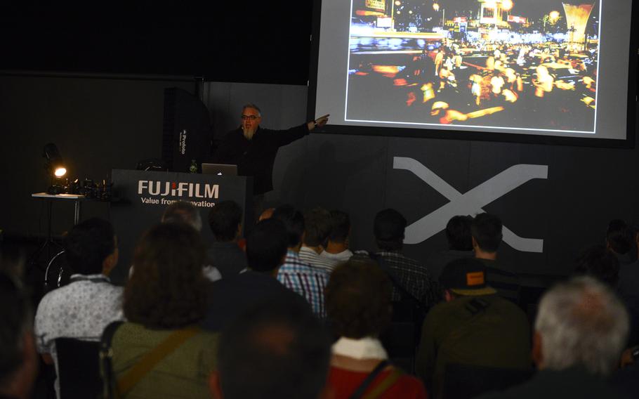 Zach Arias, a professional photographer, makes a presentation on behalf of Fujifilm on the opening day of the Photokina trade fair, Tuesday Sept. 16, 2014, in Cologne, Germany.