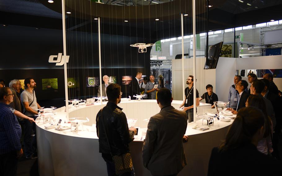 A DJI representative demonstrates the use of one of the company's drones on opening day of the Photokina trade fair, Tuesday Sept. 16, 2014, in Cologne, Germany.The fair runs through Sept. 21.