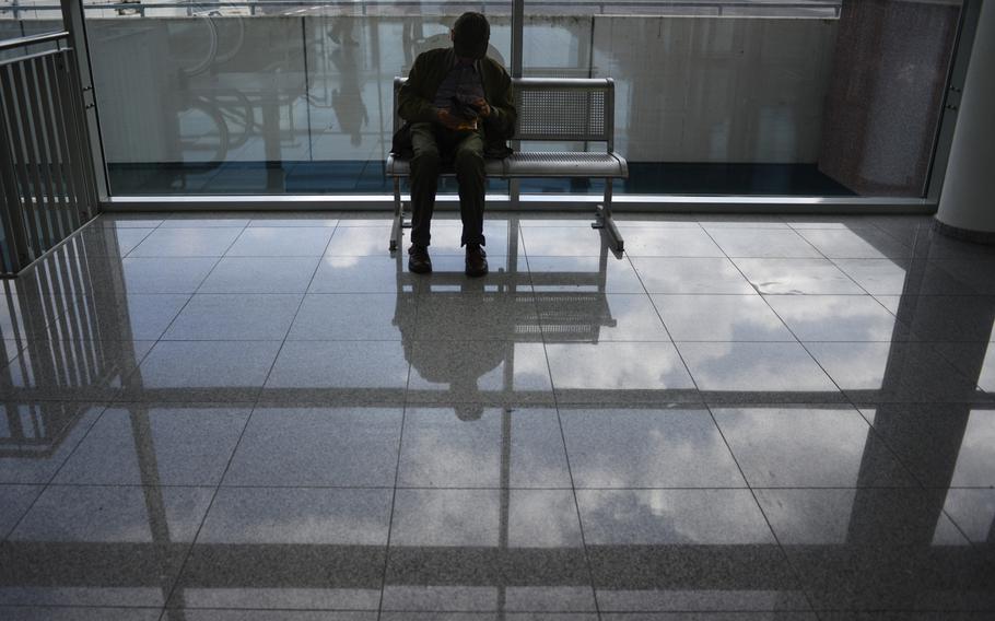 A visitor takes a break on opening day of Photokina, Tuesday Sept. 16, 2014, Cologne, Germany.