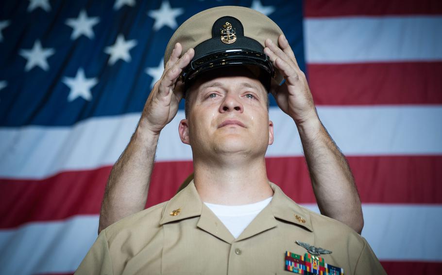 Chief Petty Officer David West, from Mt. Vernon, Wash., receives his cover during a pinning ceremony for newly selected chiefs in the hangar bay of the aircraft carrier USS Nimitz on Monday, Sept. 15, 2014. Twenty-four Sailors aboard Nimitz were pinned to the rank of chief petty officer.