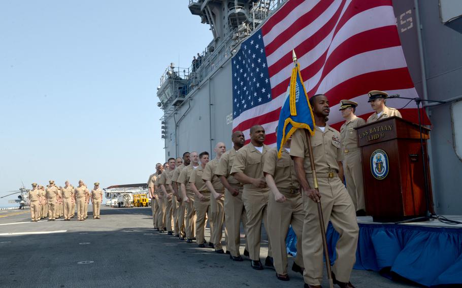 Chief Petty Officer selectees sing "Anchors Aweigh" as they march to their pinning ceremony on the flight deck aboard amphibious assault ship USS Bataan on Tuesday, Sept. 16, 2014. Bataan is the flagship for the Bataan Amphibious Ready Group. With the embarked 22nd Marine Expeditionary Unit, it is deployed in the U.S. 5th Fleet area of responsibility.