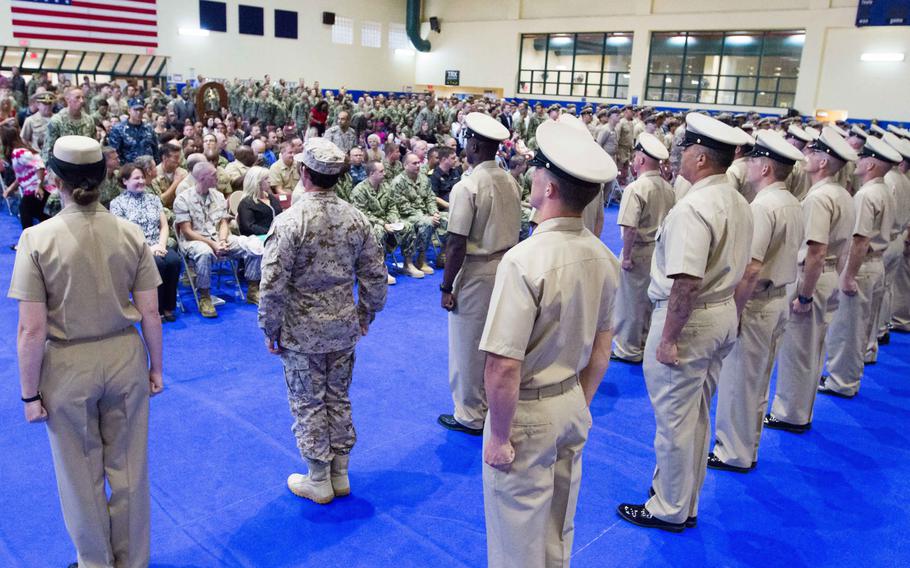 Fifty-five newly pinned chief petty officers sing "Anchors Aweigh" in front of family, friends, and other servicemembers at Naval Support Activity Bahrain on Tuesday, Sept 16,2014.