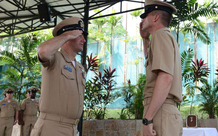Chief Petty Officer Jarret McKinney, right, requests permission to enter the chiefs' mess from Command Master Chief Richard O'Rawe during a chief's pinning ceremony at Navy Region Singapore on Tuesday, Sept. 16, 2014.