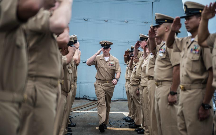 Chief Petty Officer Eric Wemmer, from Rainier, Ore., is piped into the chiefs' mess during a pinning ceremony on board Arleigh Burke-class destroyer USS Halsey on Tuesday, Sept. 16, 2014. The Halsey is currently participating in Valiant Shield, which is a U.S.-only exercise integrating Navy, Air Force, Army, and Marine Corps assets.