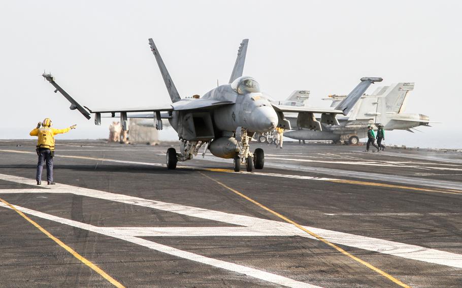 An F/A-18 Super Hornet lands on the aircraft carrier USS George H.W. Bush in the Persian Gulf, Aug. 10, 2014. Sailors and Marines on lengthy deployments began accruing a new allowance on Wednesday, Sept. 17, 2014, known as Hardship Duty Pay-Tempo. The allowance applies to all active-duty and reserve troops on operational deployments of more than 220 days.