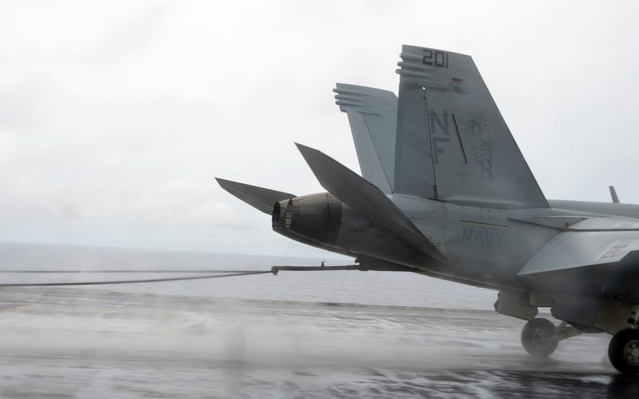 An arresting wire takes an F-18 flying at roughly 150 mph and stops it in about two seconds during flight operations aboard the USS George Washington on Sept. 17, 2014, in waters near Guam.