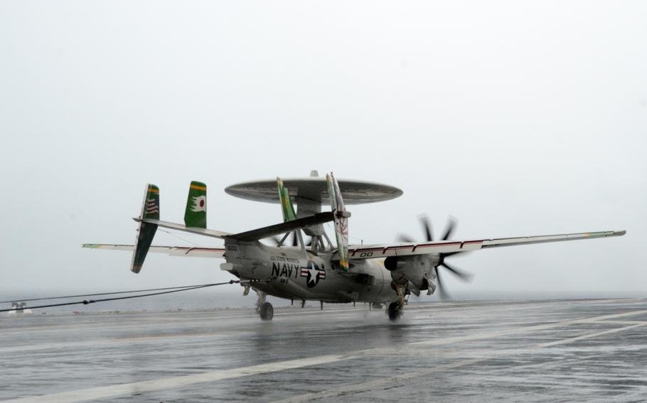 An E2-C Hawkeye lands aboard the USS George Washington in water near Guam on Sept. 17, 2014. The aircraft is participating in Valiant Shield 2014, this year's largest U.S.-only military exercise.