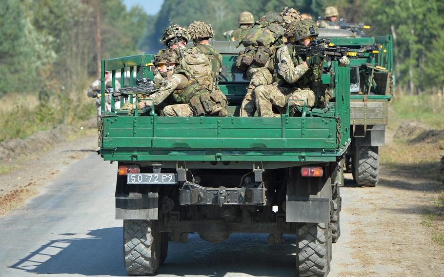 British soldiers keep alert during convoy training at Exercise Rapid Trident near Yavoriv, Ukraine, Wednesday, Sept. 17, 2014. About 1,300 troops are taking part in the exercise, which comes during a time of war for Ukraine.