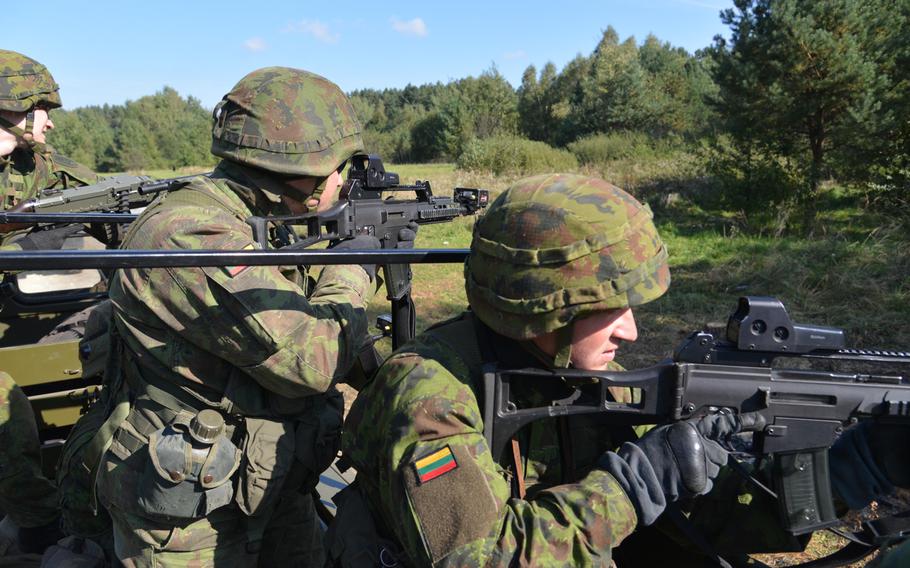 Lithuanian soldiers look for danger during convoy training at Exercise Rapid Trident near Yavoriv, Ukraine, Wednesday, Sept. 17, 2014.