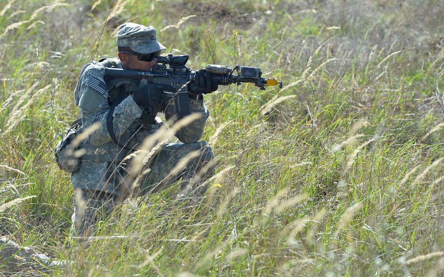 Pfc. Chaen McBean of the 173rd Airborne Brigade plays a member of the opposing force during patrol training at Exercise Rapid Trident near Yavoriv, Ukraine, Wednesday, Sept. 17, 2014.