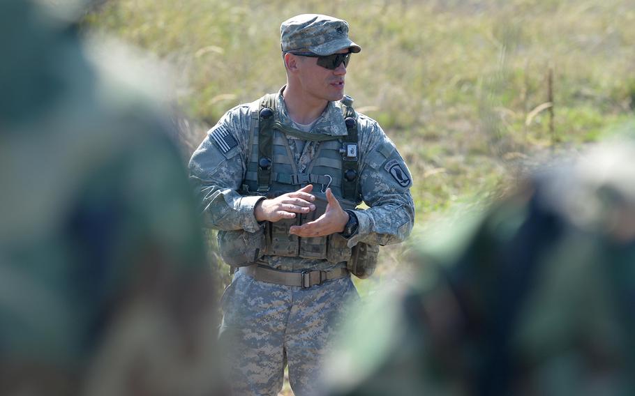 Staff Sgt. Byron Prohovich of the 173rd Airborne Brigade talks to soldiers from Azerbaijan after instructing them in patrol tactics at Exercise Rapid Trident near Yavoriv, Ukraine, Wednesday, Sept. 17, 2014.