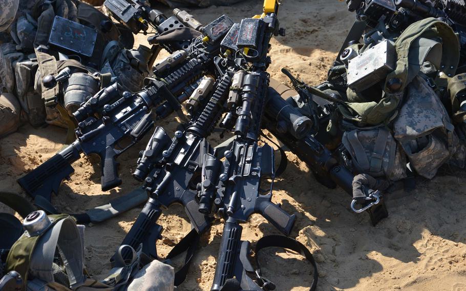 Weapons and gear of 173rd Airborne Brigade soldiers sit in the sand at Exercise Rapid Trident near Yavoriv, Ukraine, Wednesday, Sept. 17, 2014. Fifteen counties are taking part in the exercise that lasts until Sept. 26.